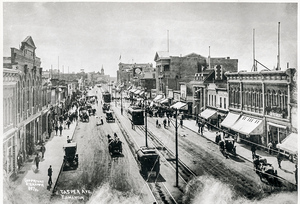 View of Jasper Avenue, vintage cars, horse & buggy teams, and Streetcars running on direct current power in 1910. Note the carbon arc street lights (AC powered)