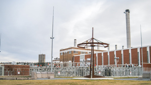 Rossdale 72kv the Rossdale Power Plant (background). The tall metal structures are lis a natightning protection for switchyard apparatus (yard lights mounted on steel poles). The foreground structure marks the Fort Edmonton Cemetery.