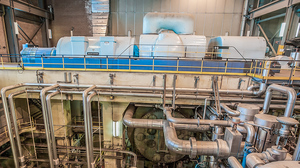 Unit #8 feedwater heaters with associated piping and condenser in foreground and turbine unit on floor above in the background.